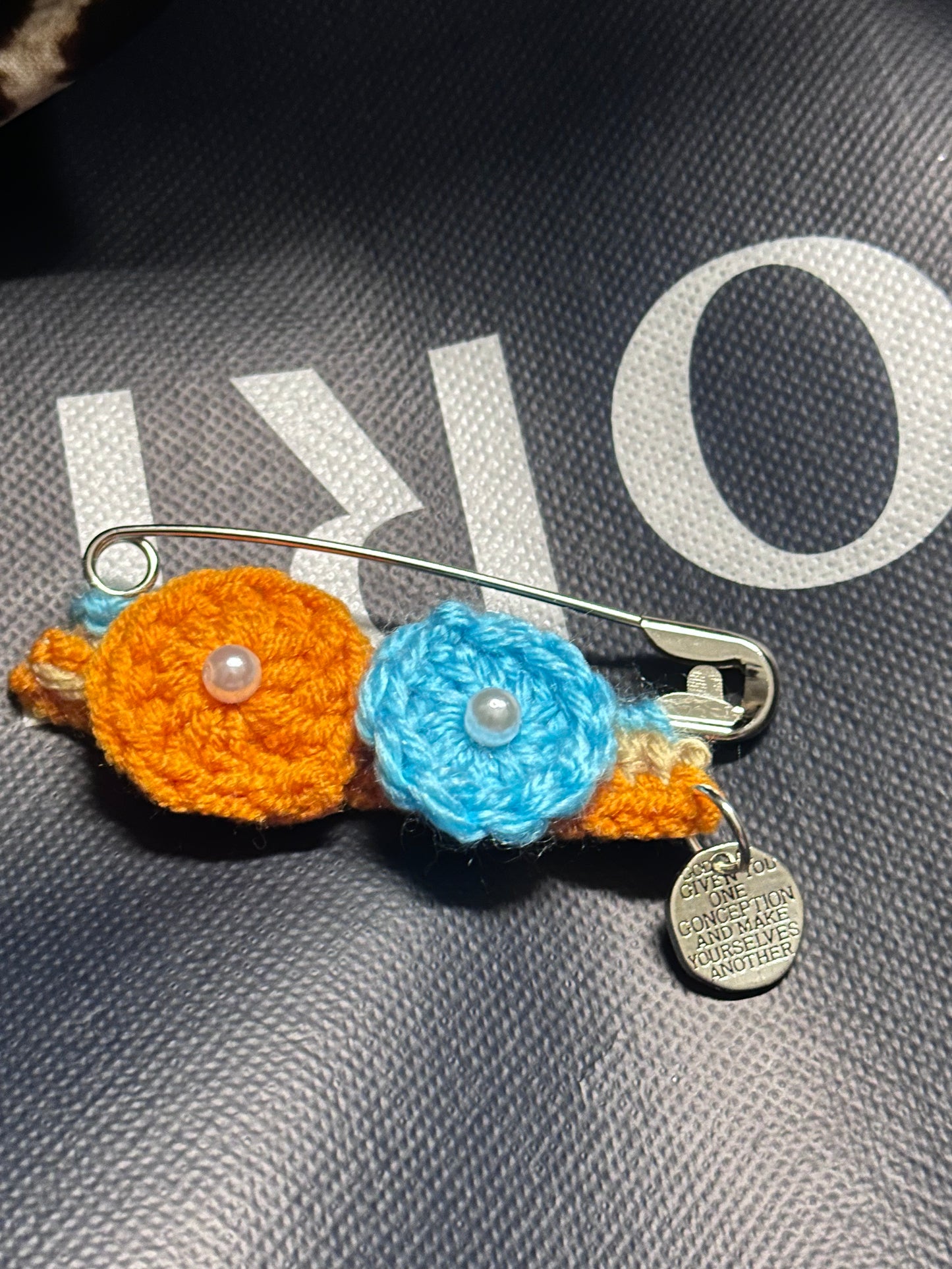 Crocheted flower with a safety pin 