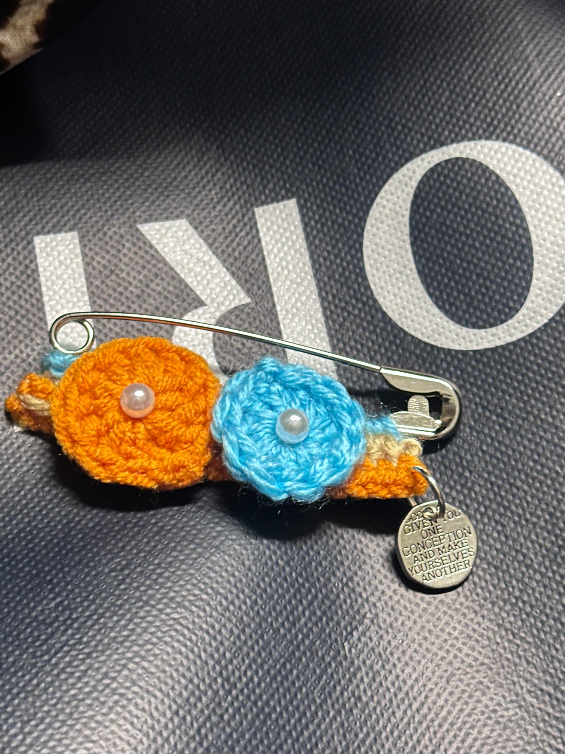 Crocheted flower with a safety pin 