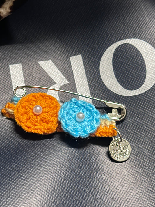 Crocheted flower with a safety pin 